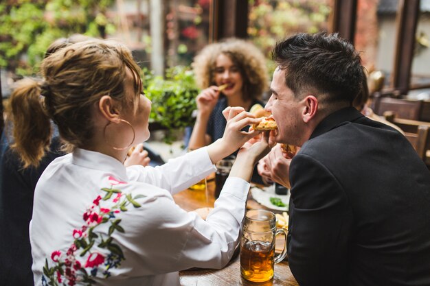 Friends eating and conversating in restaurant