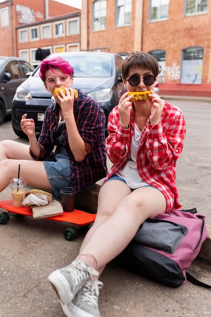 Free photo friends eating corn outdoors