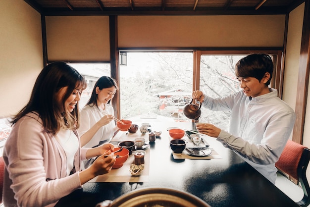 Free photo friends eating tasty  food medium shot