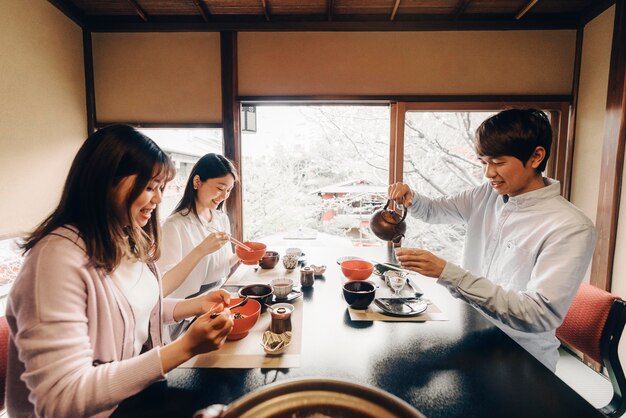 おいしい食べ物を食べる友達ミディアムショット