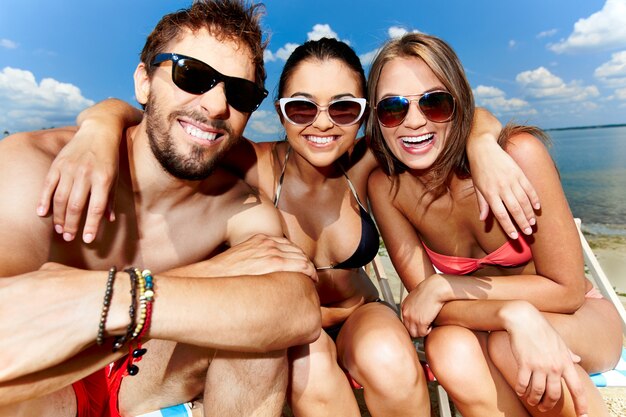 Friends embracing on the beach