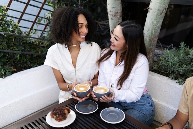 Free photo friends enjoying coffee together