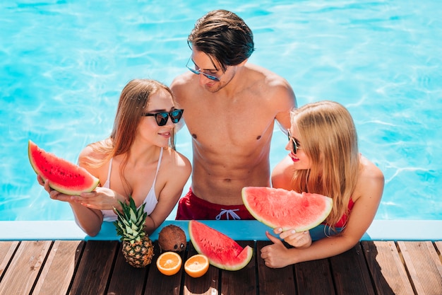 Free photo friends enjoying a fresh watermelon