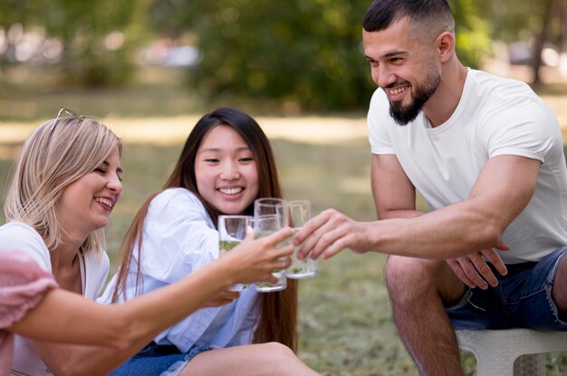 Friends enjoying a glass of lemonade together outside