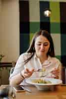 Free photo friends enjoying lunch in the restaurant, eating paste