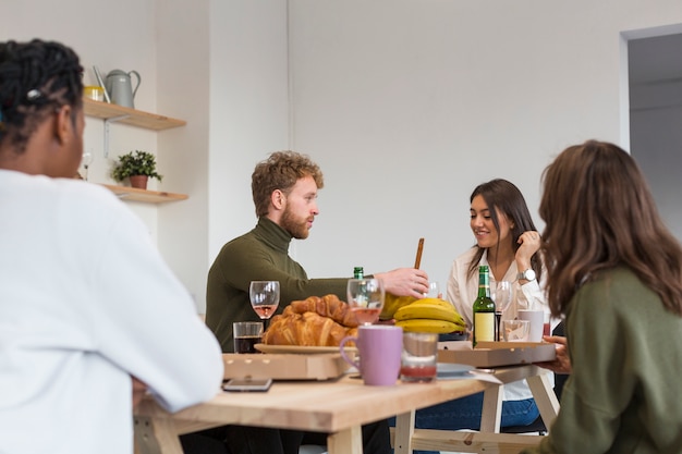 Amici godendo il pranzo insieme