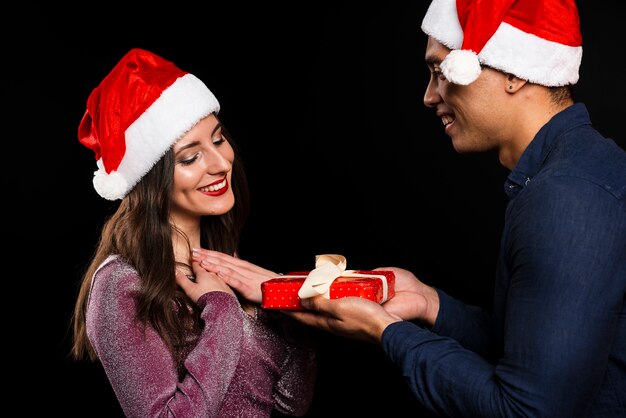 Friends exchanging gifts at new years party