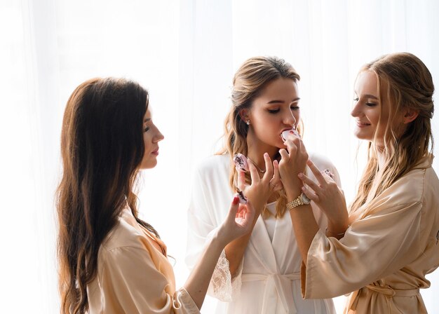 Friends Giving Bride Tasting Cakes