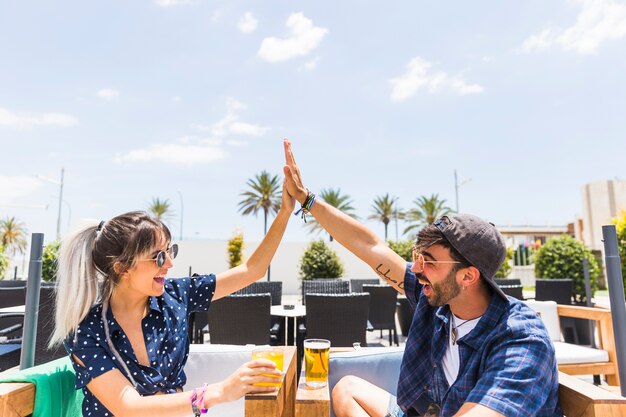 Friends giving high five to each other