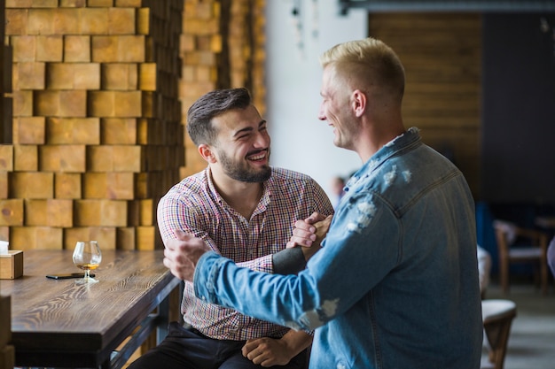 Free photo friends greeting each other with hand shake