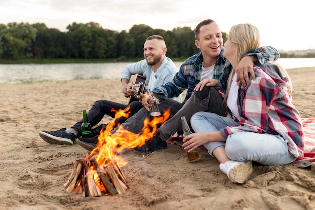 Friends hanging out at a campfire