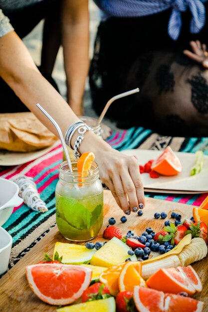 Friends having a beach party with snacks