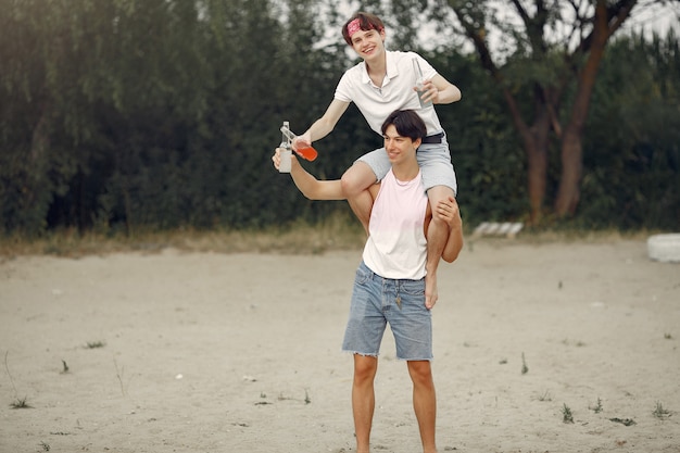 Friends having fun on a beach with drinks