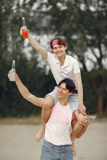 Friends having fun on a beach with drinks