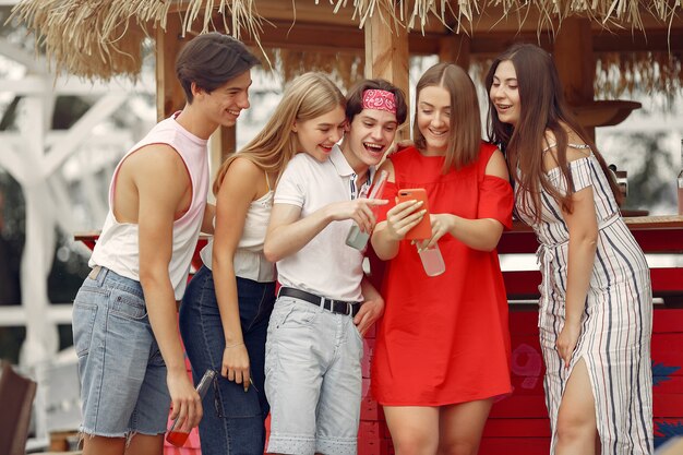 Friends having fun on a beach with drinks