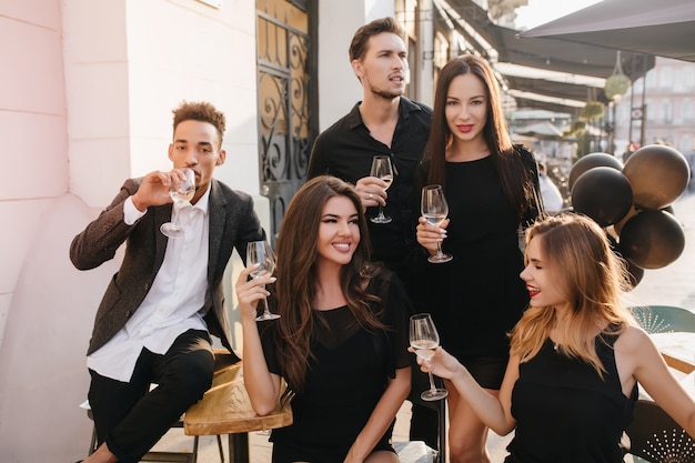 Friends having fun and drinking champagne outdoors