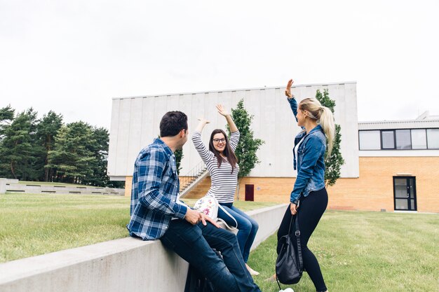 Friends having fun in university courtyard