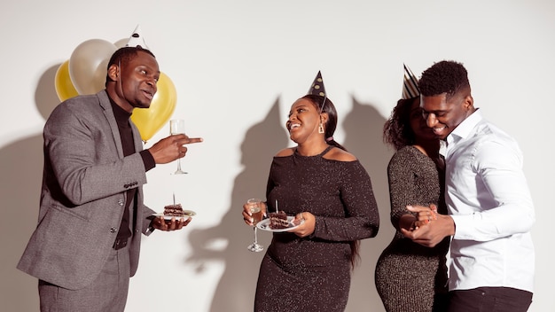 Friends having a good time and eating cake