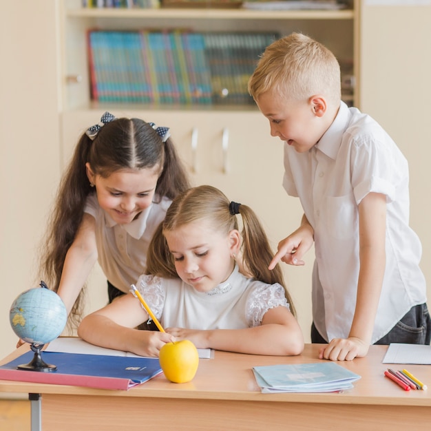 Friends helping girl to fulfill exercise