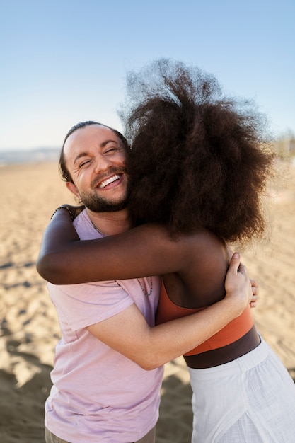 Free photo friends hugging by the sea shore