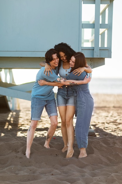 Friends hugging by the sea shore