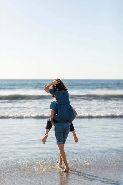 Friends hugging by the sea shore