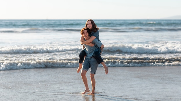 Free photo friends hugging by the sea shore