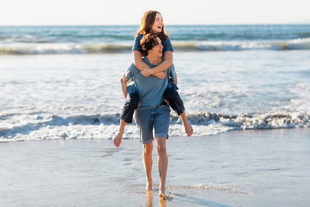 Friends hugging by the sea shore