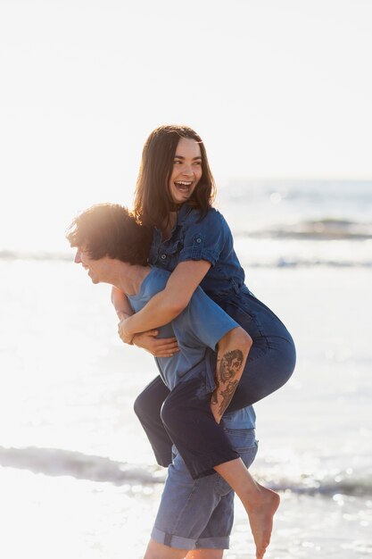 Friends hugging by the sea shore