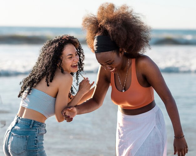 Friends hugging by the sea shore