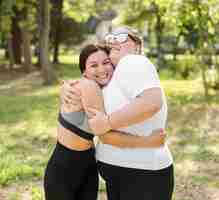 Free photo friends hugging in the park