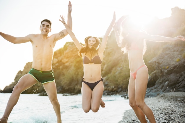 Friends jumping at the beach