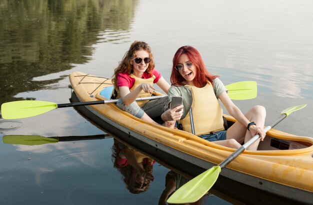Friends in kayak taking selfie