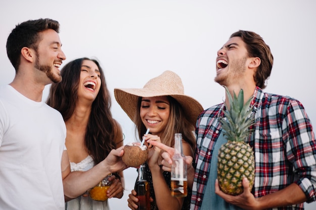 Free photo friends laughing at a beach party