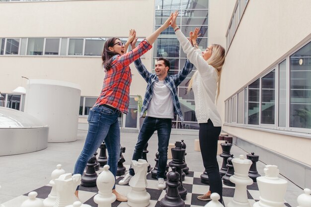 Friends laughing and giving high five