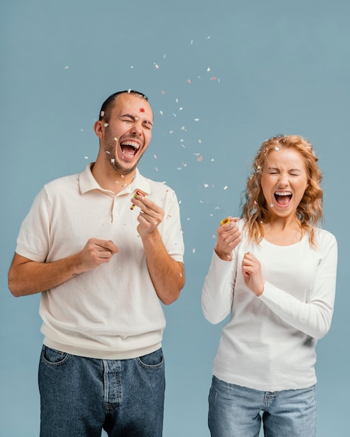 Friends laughing and popping confetti