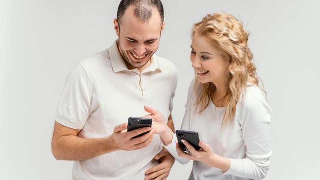 Friends laughing and using mobiles