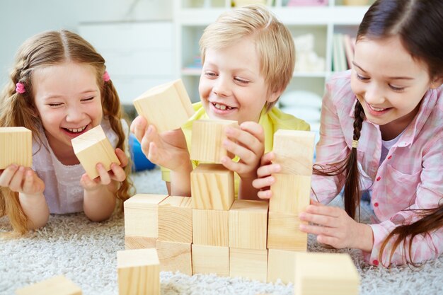Friends laughing with wooden cubes