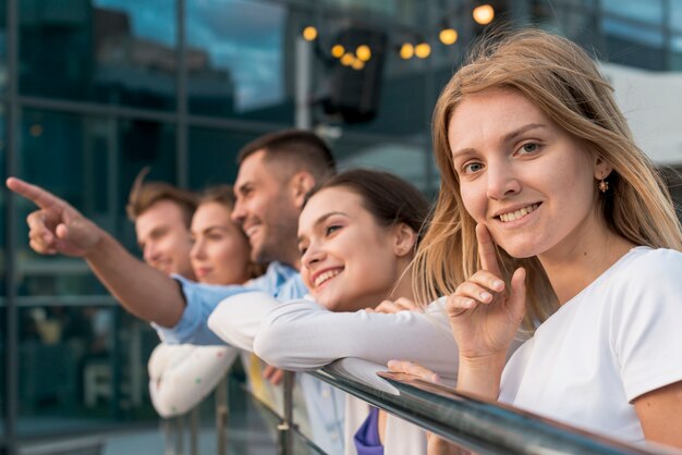 Friends leaning on a railing