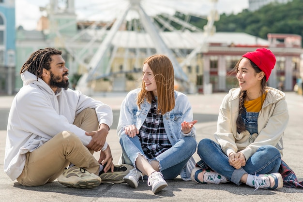 Friends at london eye sitting on floor