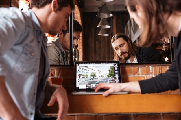 friends looking at laptop, new website