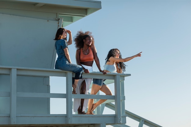 Friends looking over sea from the lifeguard tower