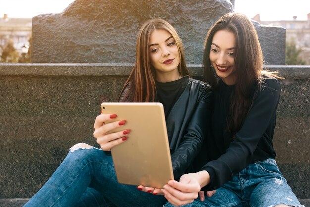 Friends looking at a tablet