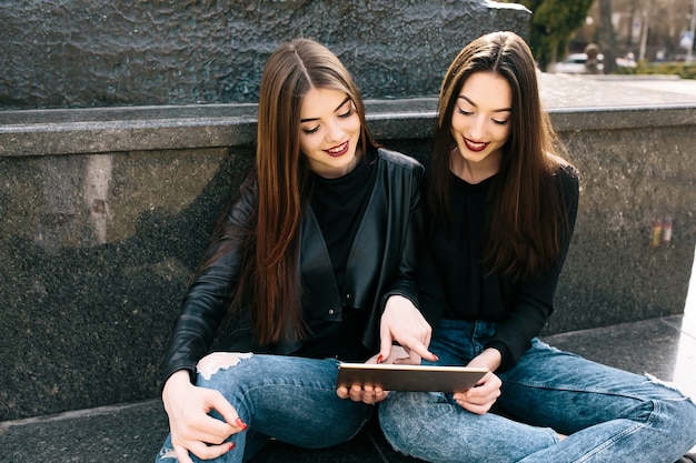 Friends looking a tablet