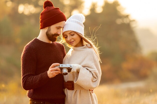 Friends looking together at photos on camera