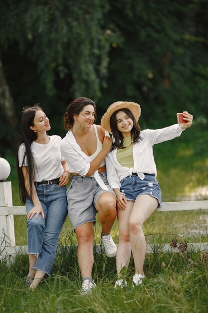 Free Photo friends makes a selfie. girl in a hat. woman in a white t-shirt.