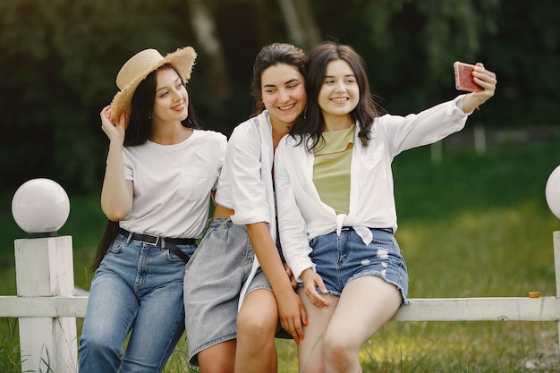 Friends makes a selfie. girl in a hat. woman in a white t-shirt.