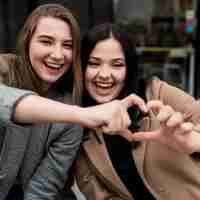 Free photo friends making a heart with their fingers