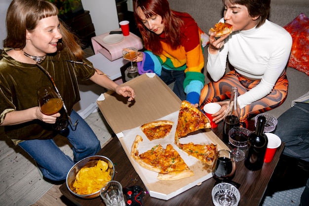 Friends at party with delicious pizza