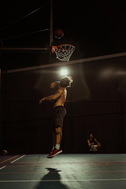 Friends play basketball. Young men play basketball in the street.